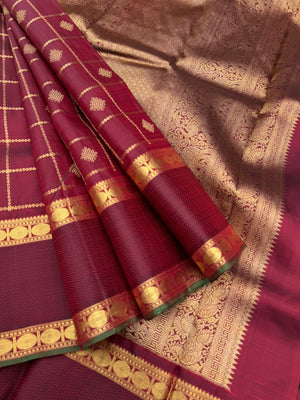 Annapoorani - the gorgeous deep maroon and gold with veldhari kolam buttas woven body with retta pett woven borders