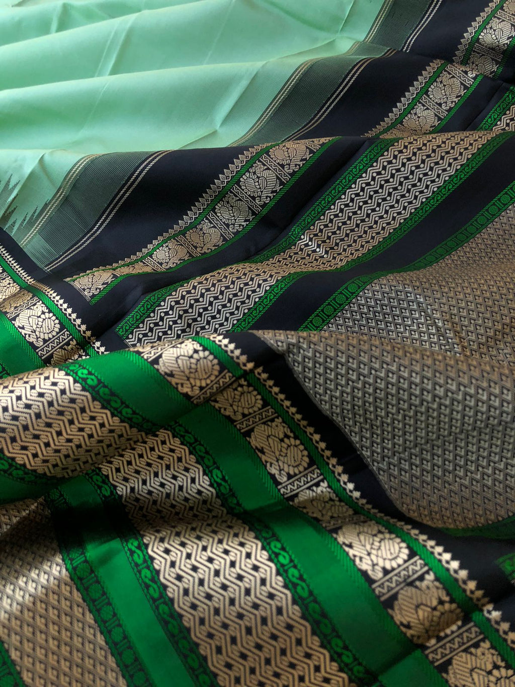 Silk Play on No Zari Kanchivaram - stunning pastel pale pista green and black with broad woven borders