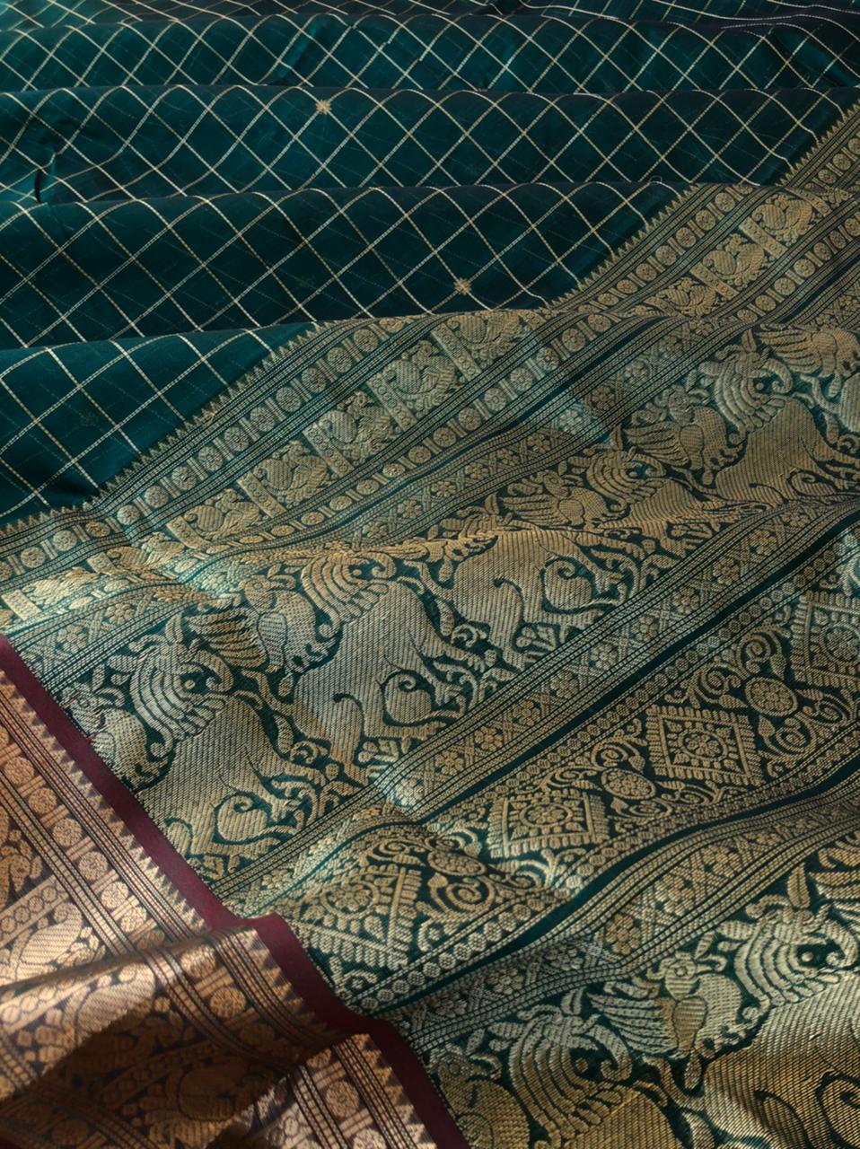 Zari Kissed Silk Cotton - gorgeous deep Meenakshi green muthukattam and buttas woven body with annapakshi woven borders