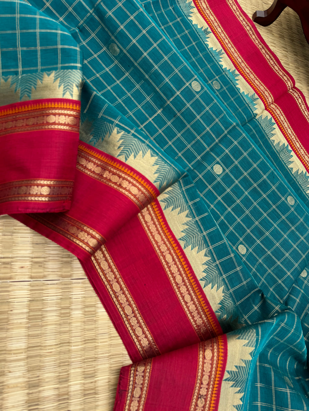 Zari Kissed Silk Cotton - a burnt oil blue and brick red with all traditional elements in one saree