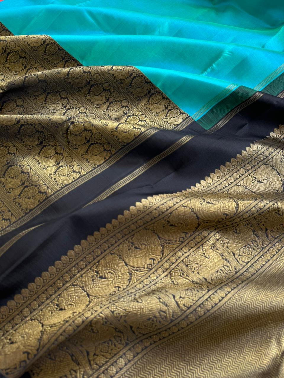 Tasteful Tall Border Kanchivarams - lovely dual tone blue and black with long zari woven one side korvai borders with grand pallu
