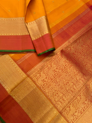 Colour Play on Kanchivaram - traditional at the best mustard and rust with aarai maadam woven borders with gorgeous grand pallu