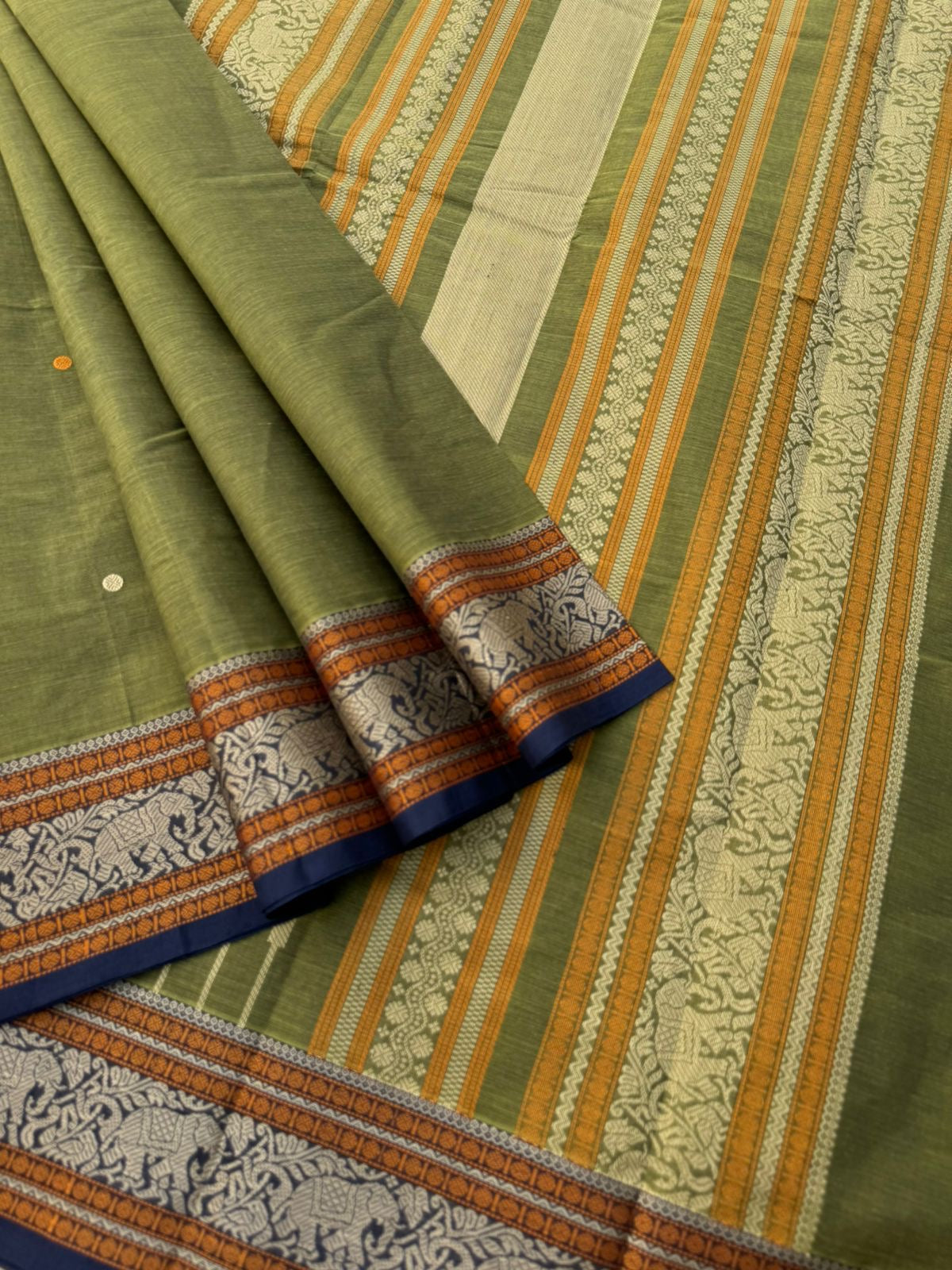 Mangalavastaram - a stunning deep algae green with elephant woven borders