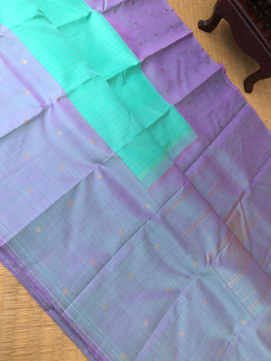 Radha Ragasiyam - Uniquely Woven Kanchivarams - a beautiful kind of sea green/pista green with broad lavender buttas woven borders