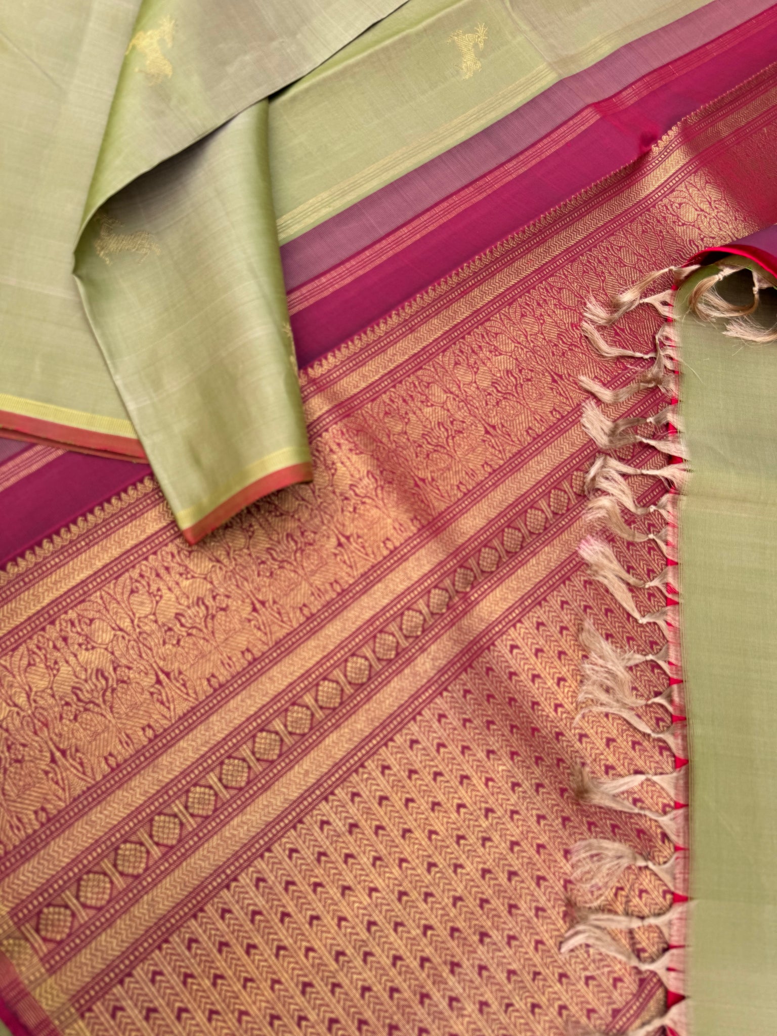 Corporate Kanchivarams - a pale elachi green and maroon borderless Kanchivaram with maan ( deer ) woven buttas