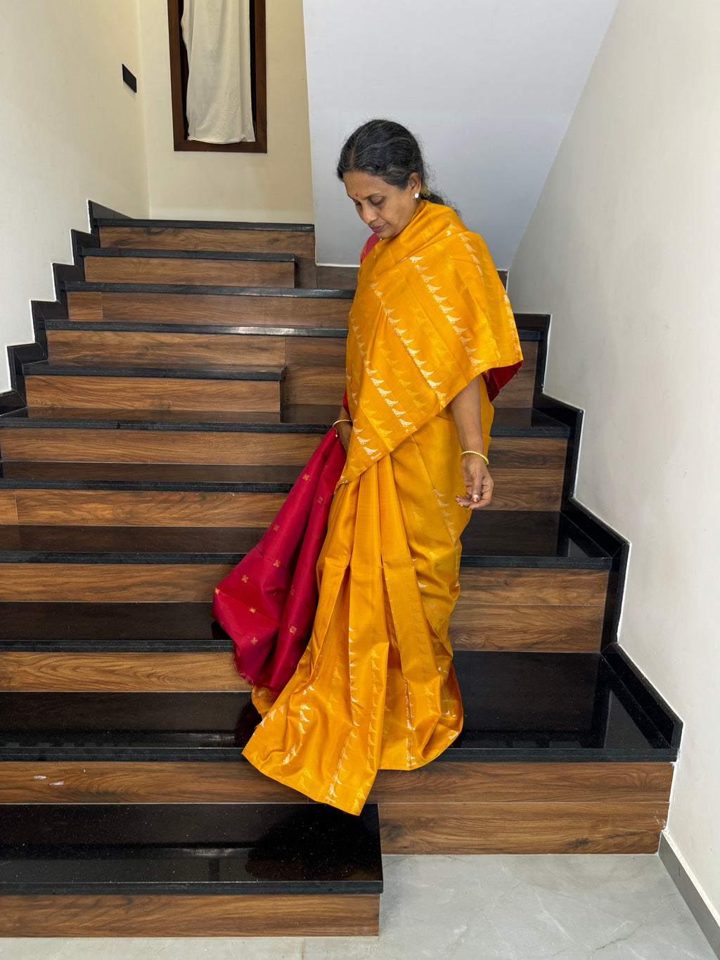 Kanchivaram Concepts - a amazing raising parrots of silver and gold zari woven buttas in a golden mustard body with red pallu and blouse