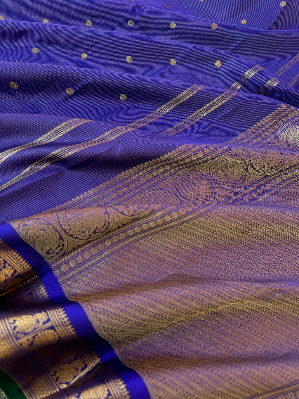 Aandal - The grandeur Kanchivaram - deep blue violet Vairaoosi with Annapakshi woven borders with green sleeve edge