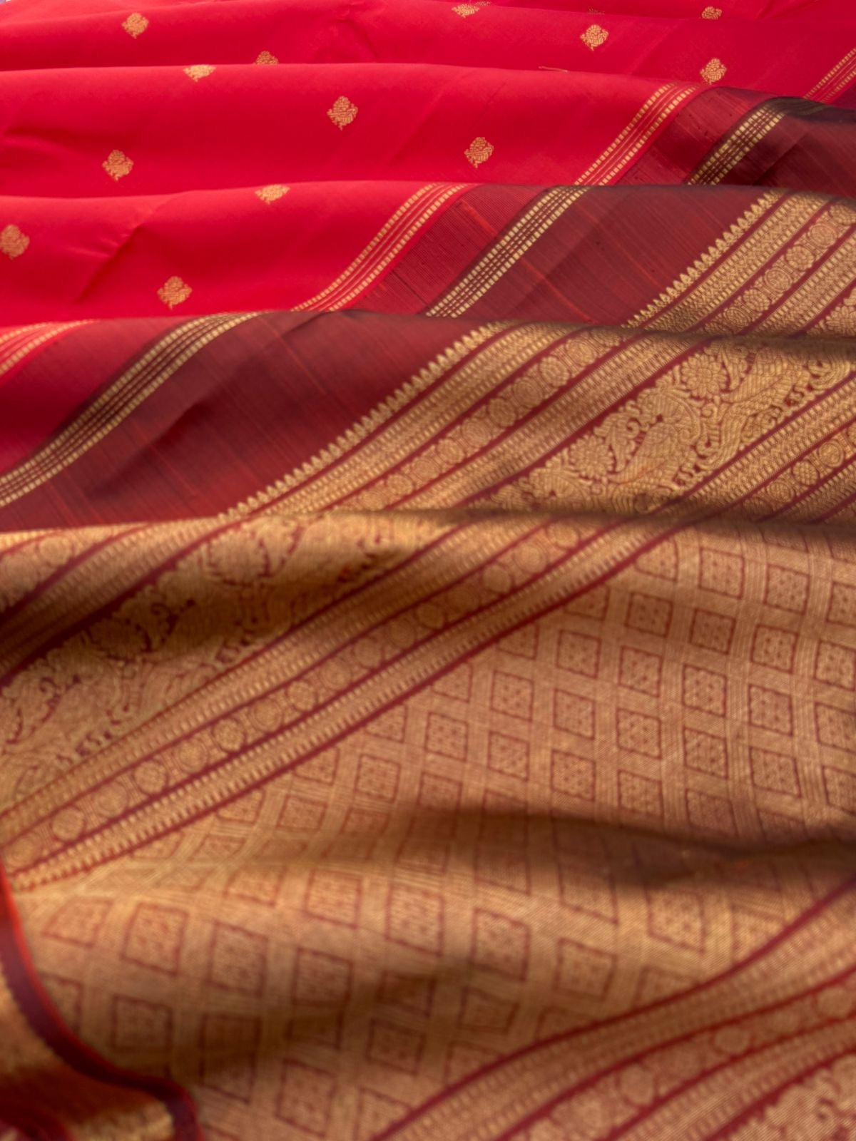 Leela - The bliss of small border Kanchivarams - brick red and maroon the best part of the saree is blouse has woven buttas