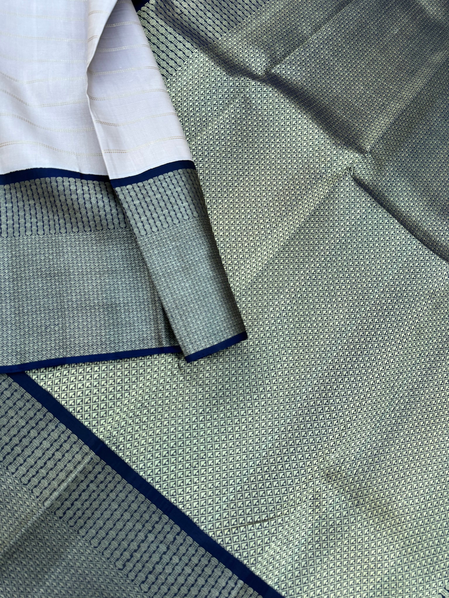 Pastel Kanchivarams - a chalk white absolutely no zari Korvai Kanchivaram with navy blue pallu and blouse