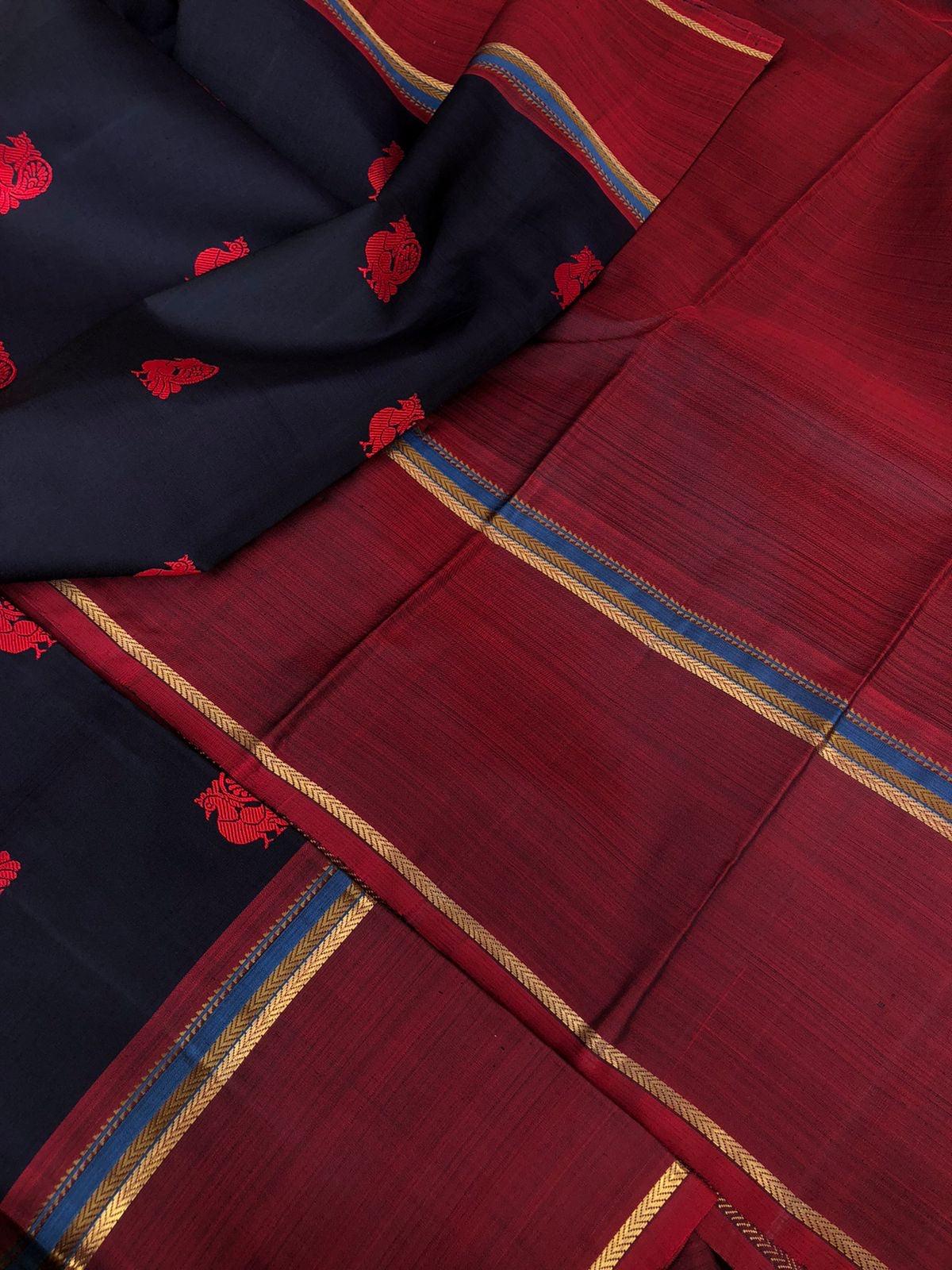 Kaavyam on Kanchivaram - the one of a kind deep mid night black blue body with annapakshi woven buttas with deep maroon borders pallu and blouse