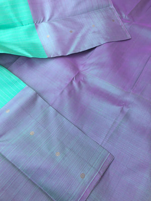 Radha Ragasiyam - Uniquely Woven Kanchivarams - a beautiful kind of sea green/pista green with broad lavender buttas woven borders