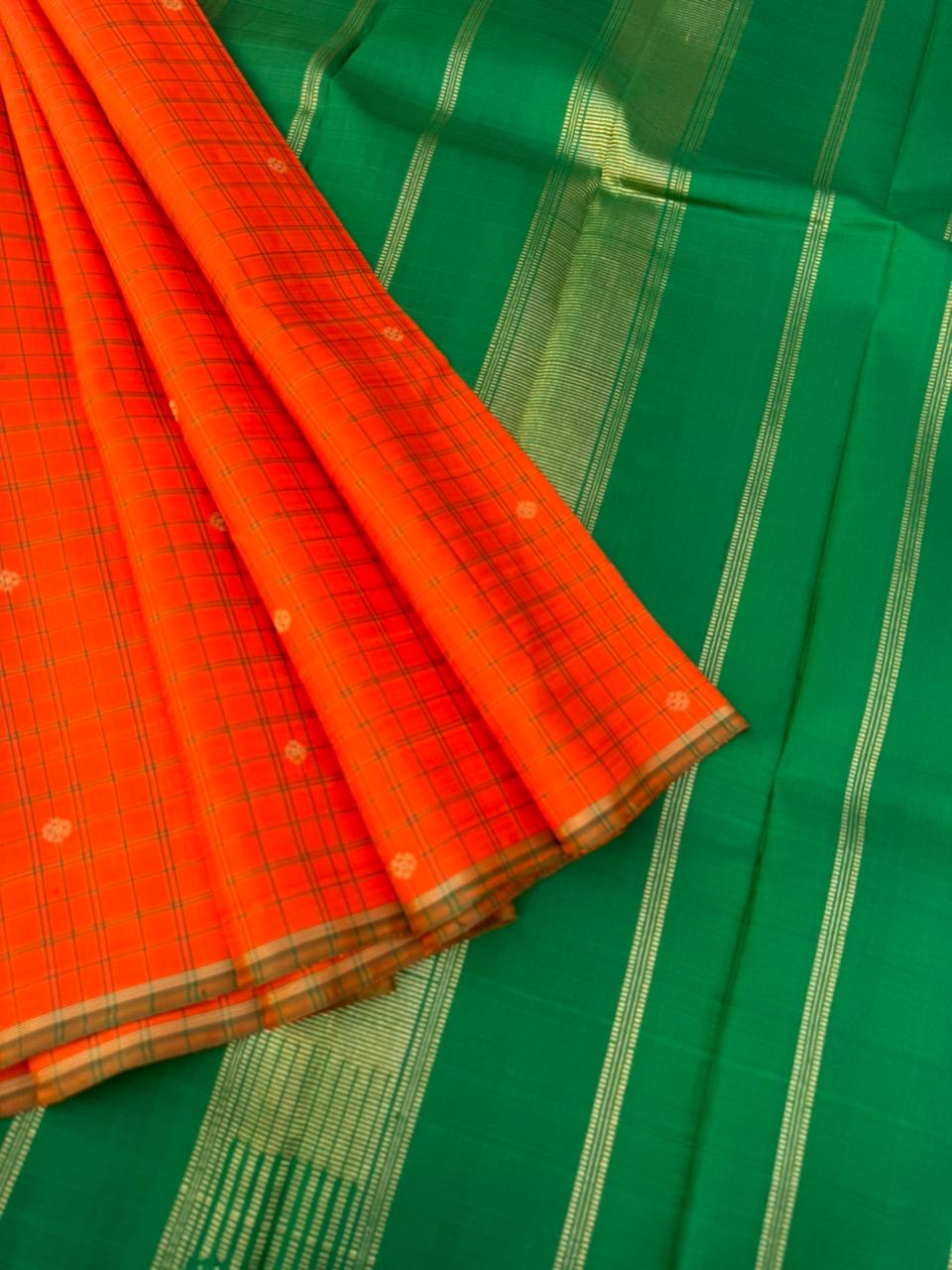 Kanchivaram Trunk - a simple elegant kattam buttas with borderless concept !! In orange and green combination