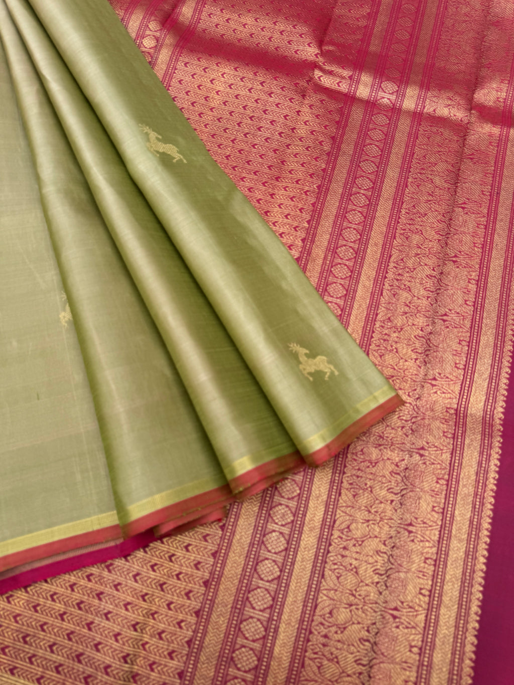 Corporate Kanchivarams - a pale elachi green and maroon borderless Kanchivaram with maan ( deer ) woven buttas
