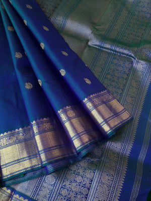 Tara - Traditional Colours on Traditional Kanchivarams - the best of dual to mayil kaluthu ( peacock neck tone blue green ) with solid gold zari woven pallu and borders