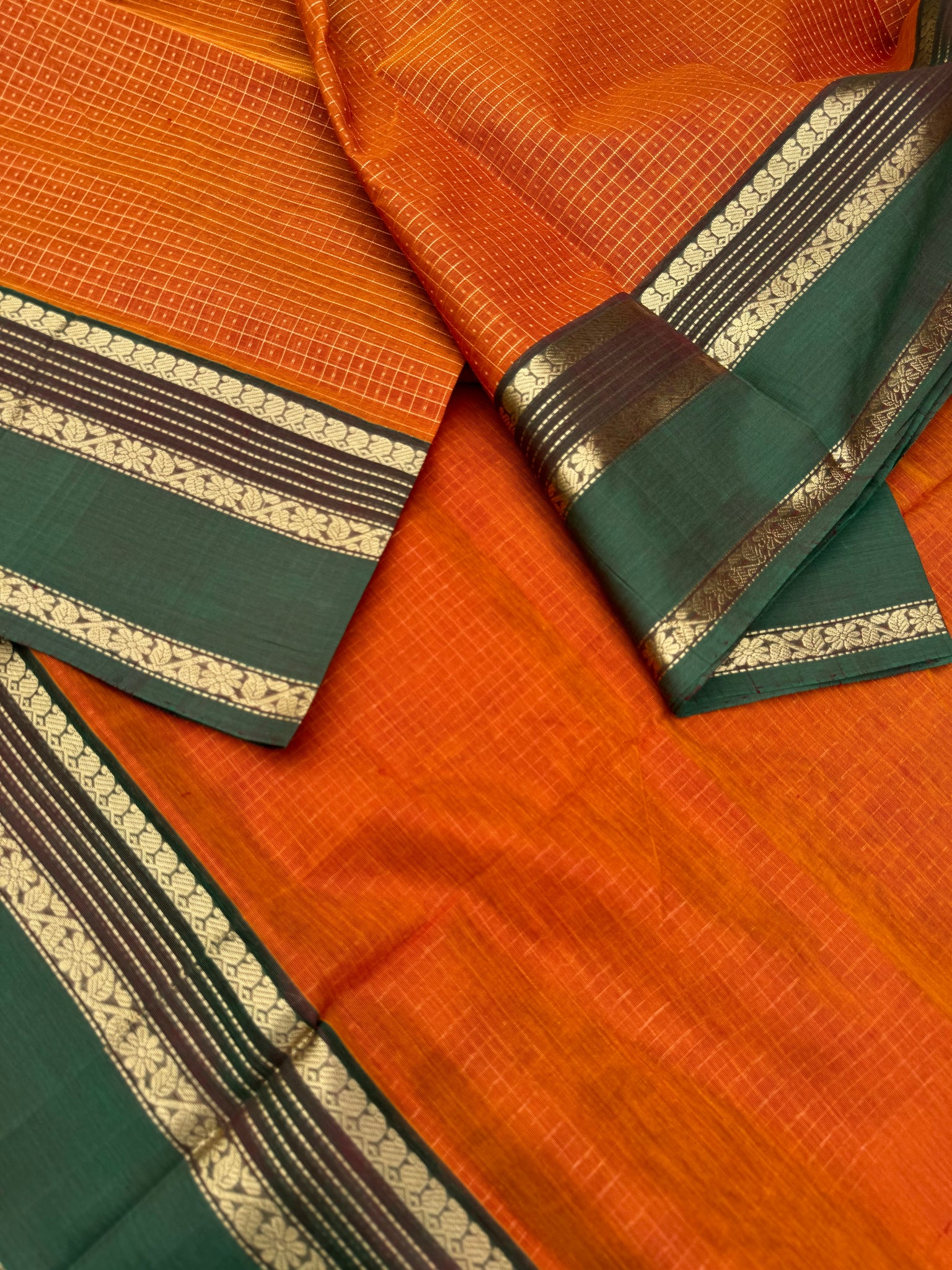 Zari Kissed Silk Cotton - rust orange and short green lakshadeepam with grand long killi woven pallu
