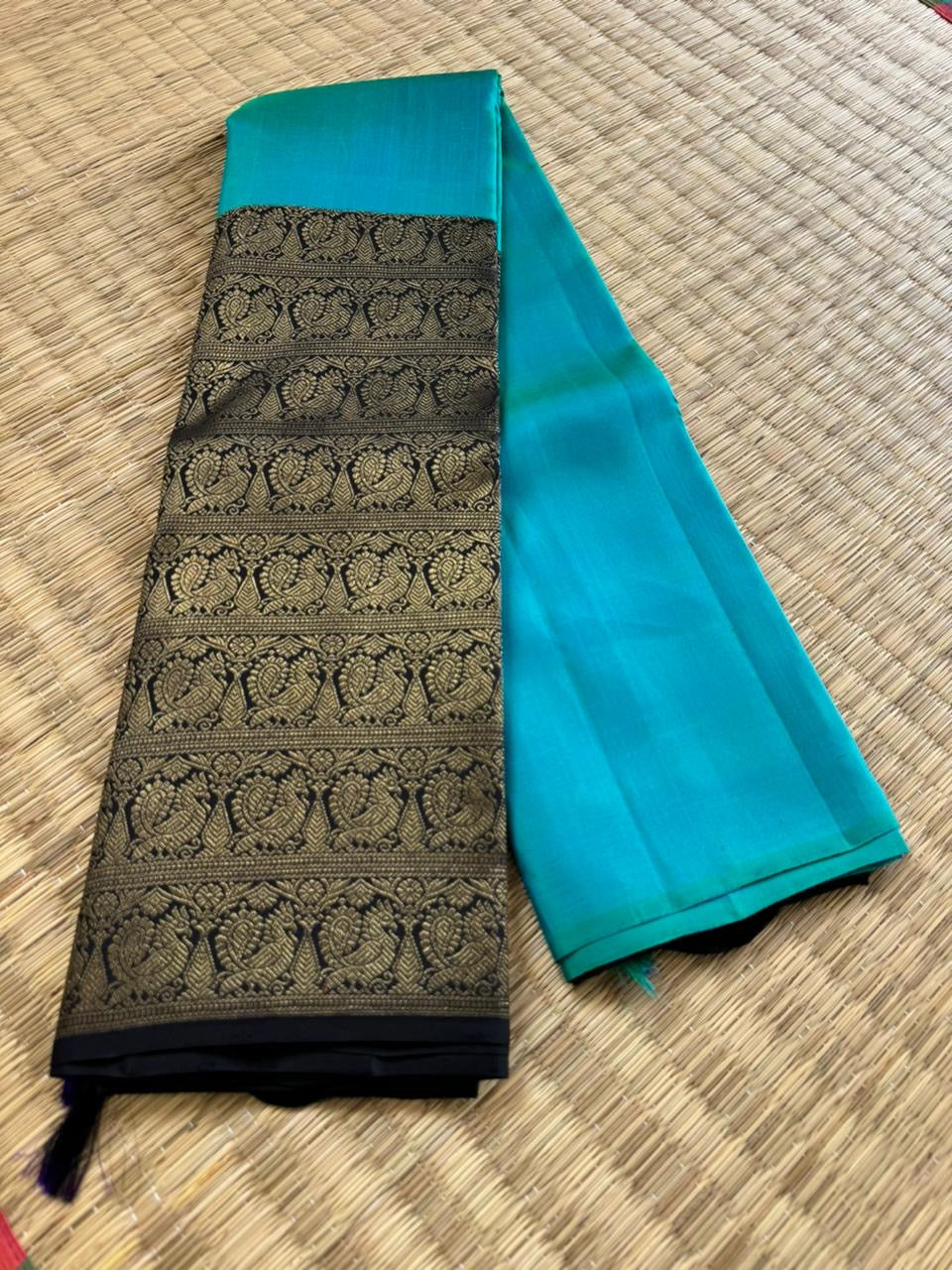 Tasteful Tall Border Kanchivarams - lovely dual tone blue and black with long zari woven one side korvai borders with grand pallu