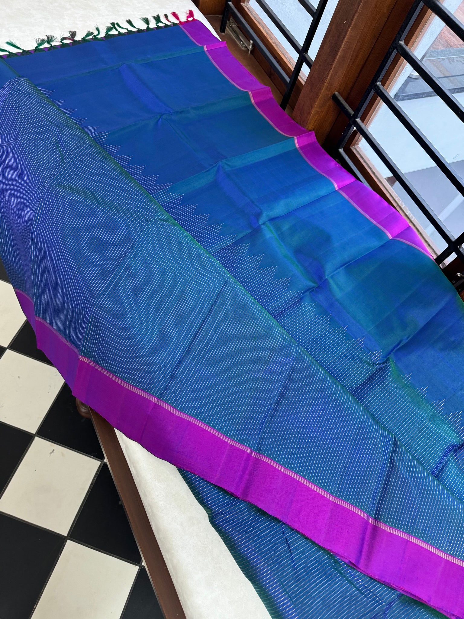 Adhyayam – The No Motifs Kanchivaram - the beautiful raising oosi vaanam in stunning dual tone peacock blue green body and majentha borders pallu and blouse