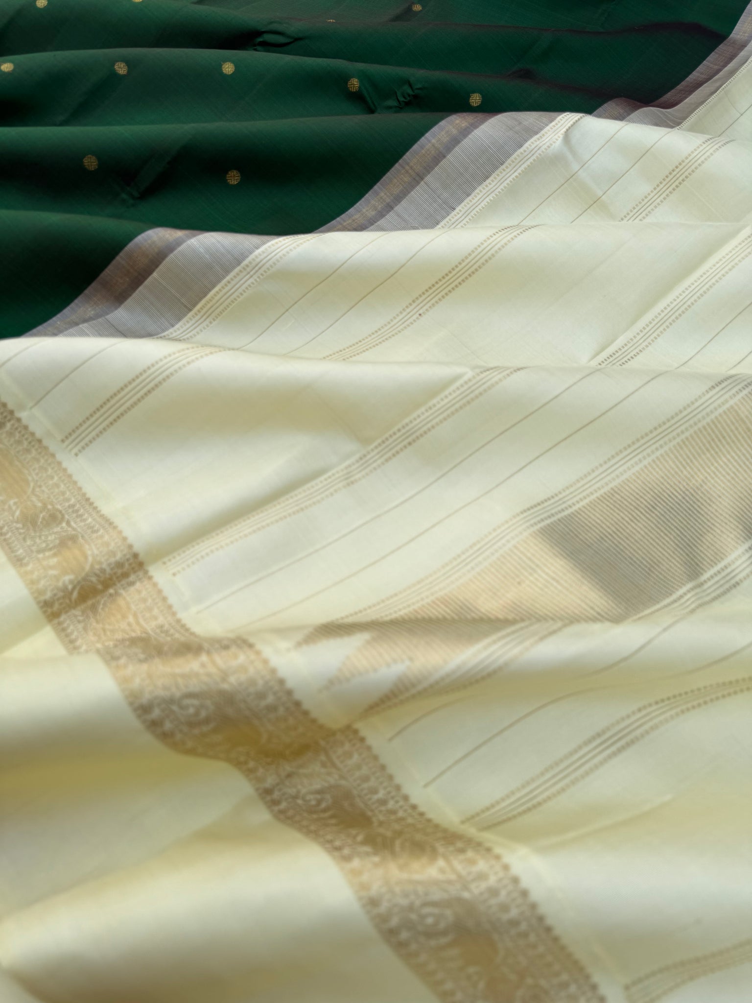 “Iyarkai” (இயற்கை) - Kanchivaram Colours Inspired from Mother Nature - a stunning deep dark bottle green and off white Korvai kanchivaram with kall erangina borders
