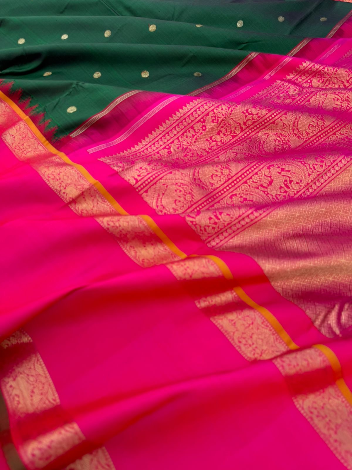Colour Play on Kanchivaram - deep dark green and pink with broad korvai woven borders