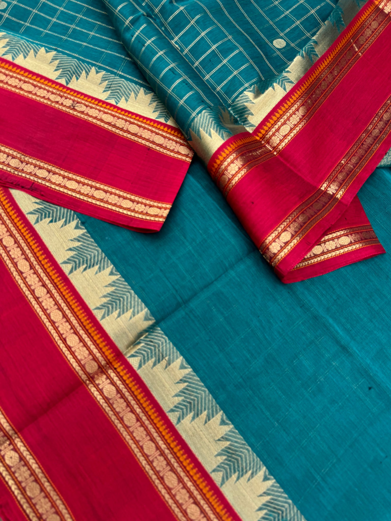 Zari Kissed Silk Cotton - a burnt oil blue and brick red with all traditional elements in one saree
