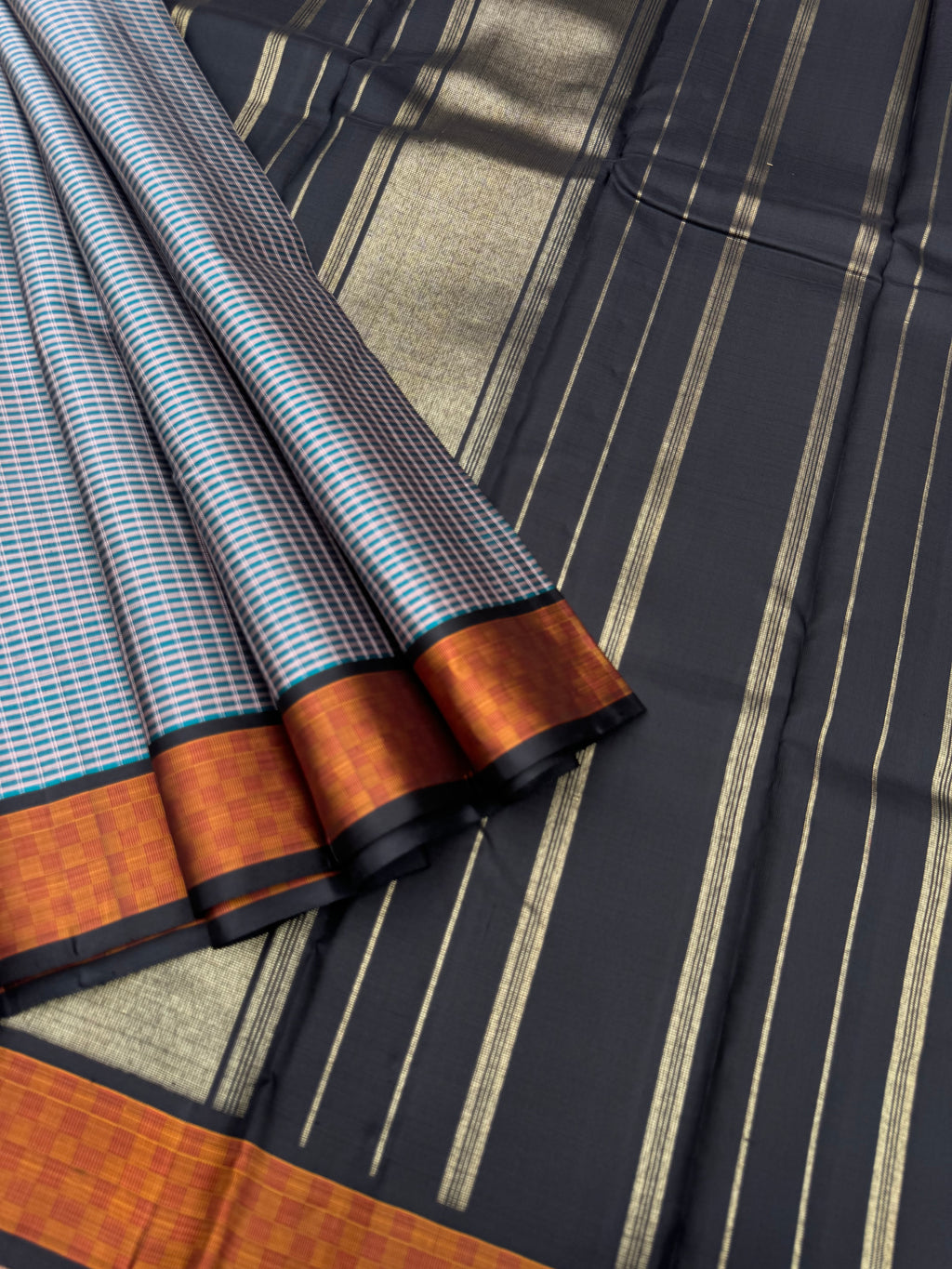 Album Vidhyasam - a metallic bluish grey kottadi kattam with mat chex borders and black pallu and blouse something unique and unusual