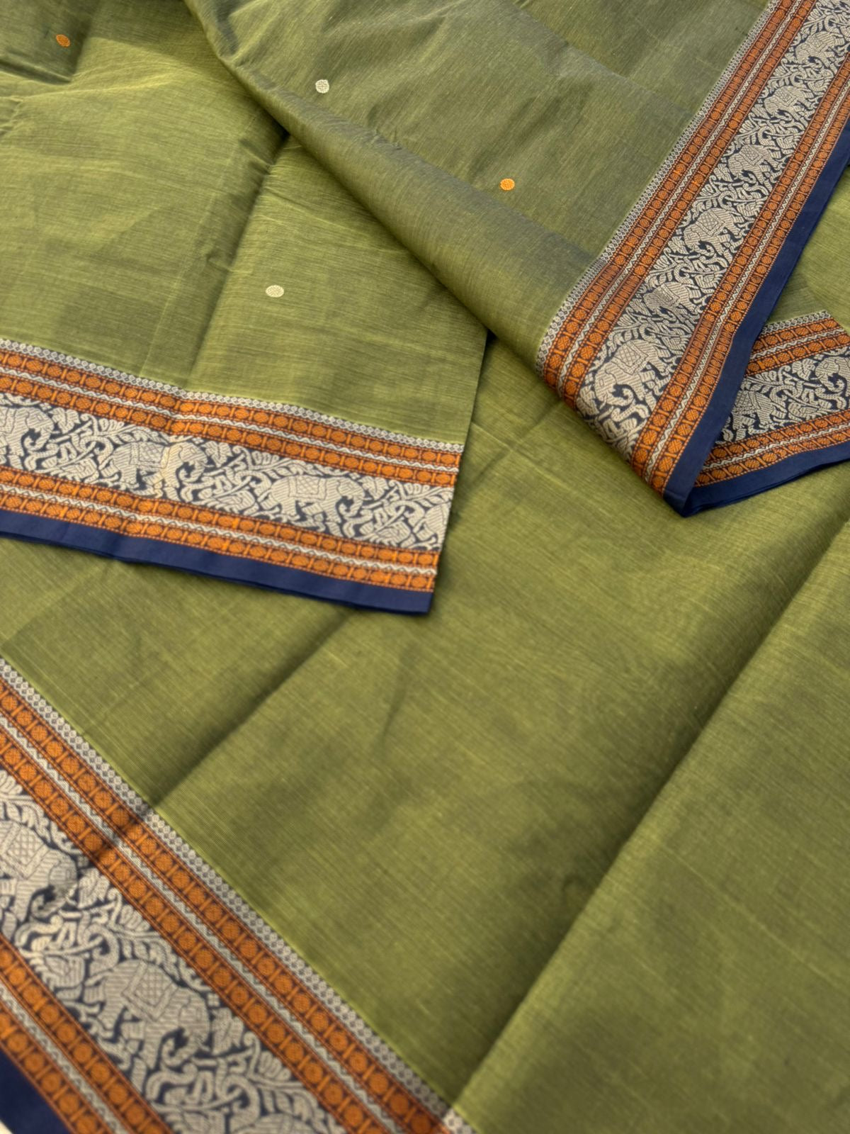 Mangalavastaram - a stunning deep algae green with elephant woven borders