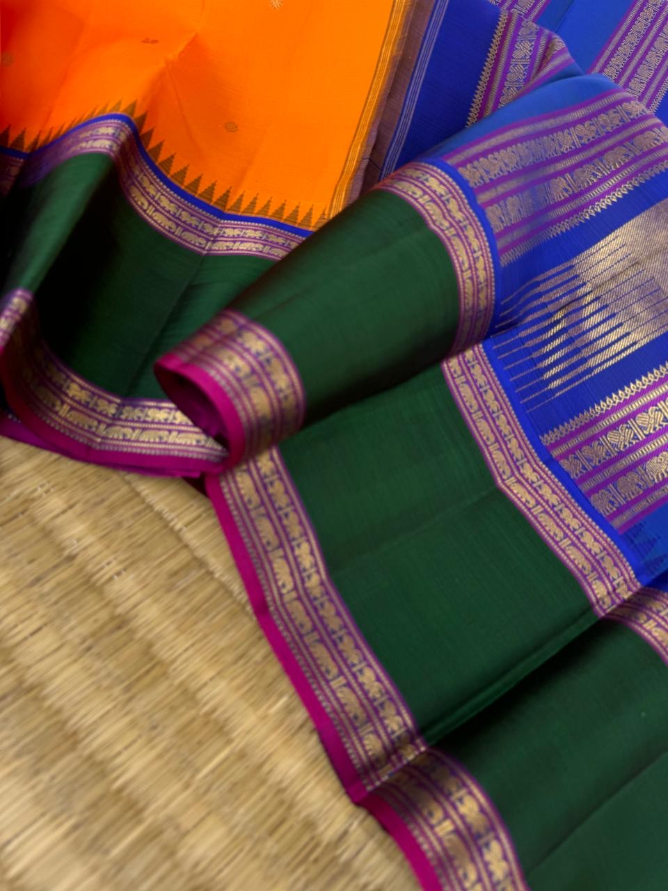 Tales of Korvais Kanchivaram - stunning carrot orange meenakshi green and intricate korvai woven borders