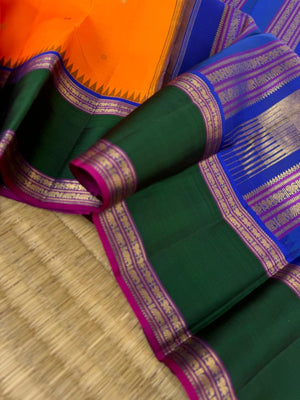 Tales of Korvais Kanchivaram - stunning carrot orange meenakshi green and intricate korvai woven borders