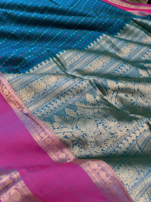 Woven Motifs Silk Cotton - a dark peacock blue lakshadeepam with retta pett woven borders