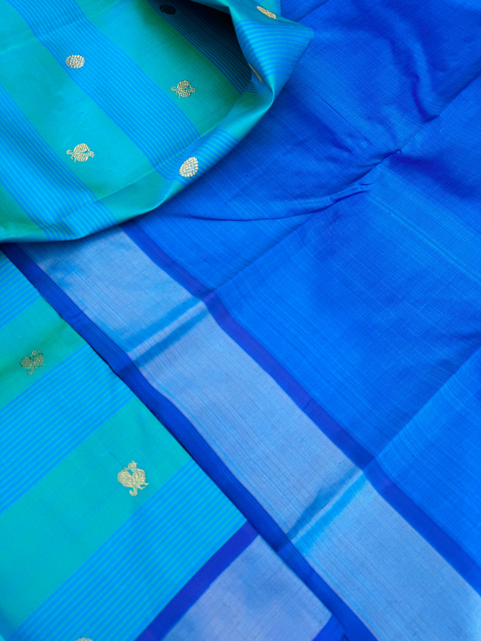 Album Untouched - a gorgeous teal and ananda blue body with mayil chackaram woven buttas