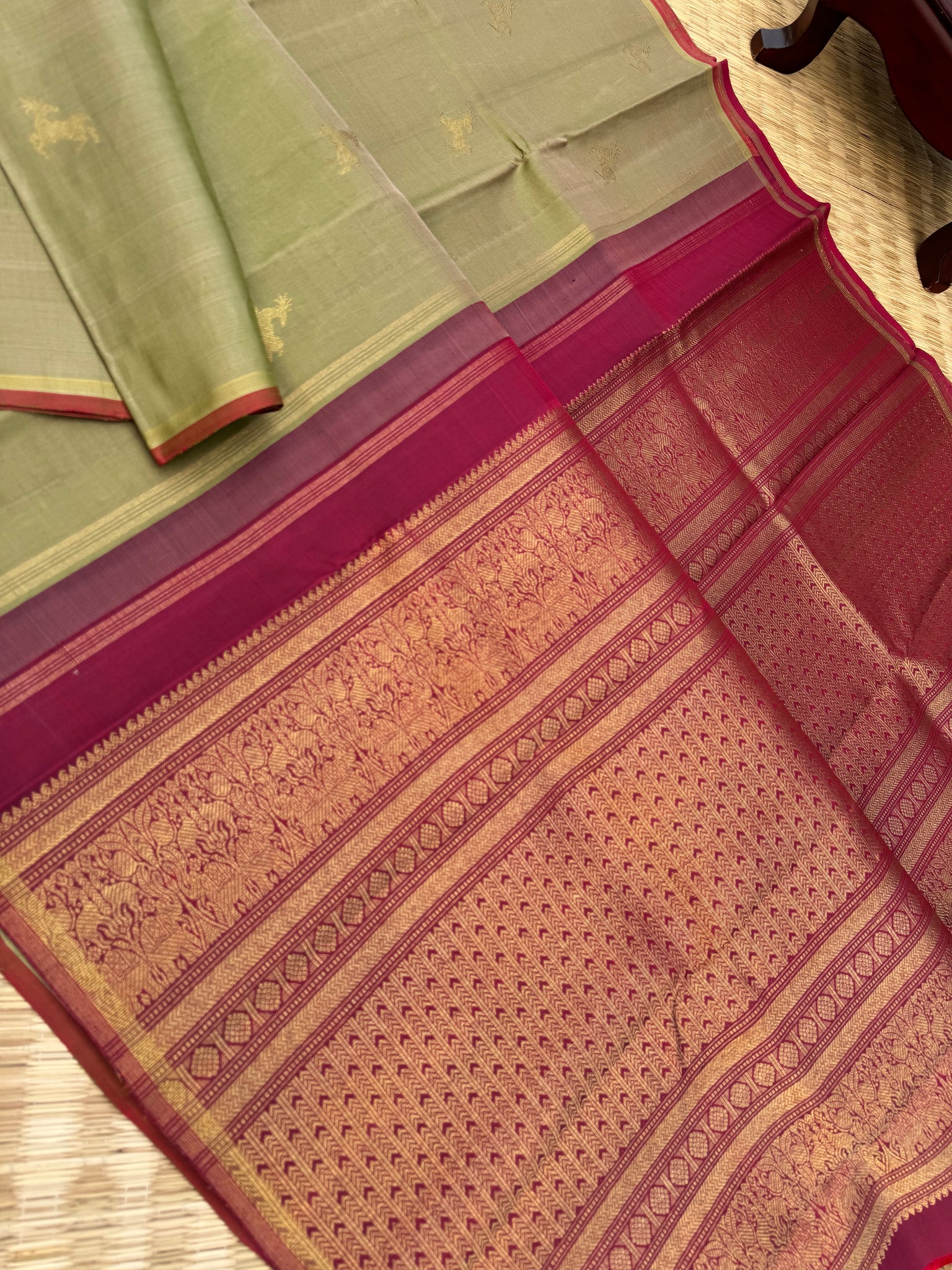 Corporate Kanchivarams - a pale elachi green and maroon borderless Kanchivaram with maan ( deer ) woven buttas