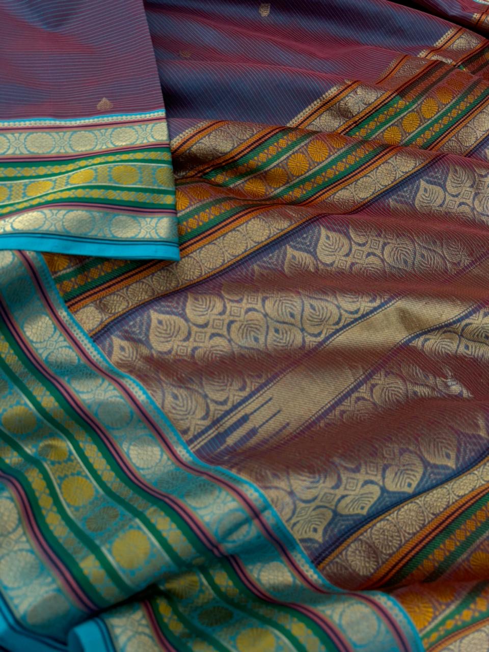 Zari Kissed Silk Cotton - a deep red short blue with laddu Kamalam motifs woven borders