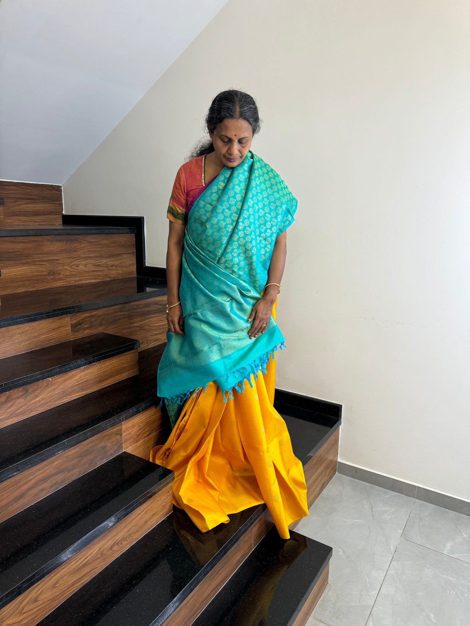 Kanchivaram Concepts - a stunning yellow and dual tone teal blue partly pallu kanchivaram with plain yellow pleats and full zari 1000 buttas woven front and pallu