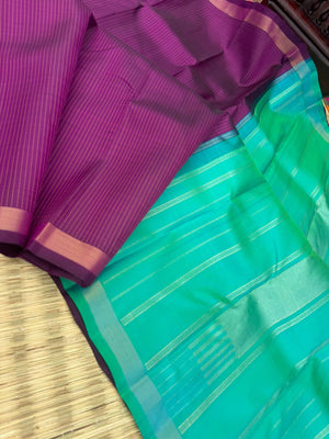 Shree - Simple and Elegant Kanchivarams - a stunning deep purple vertical muthu strips body with a dual tone turquoise blue pallu and blouse