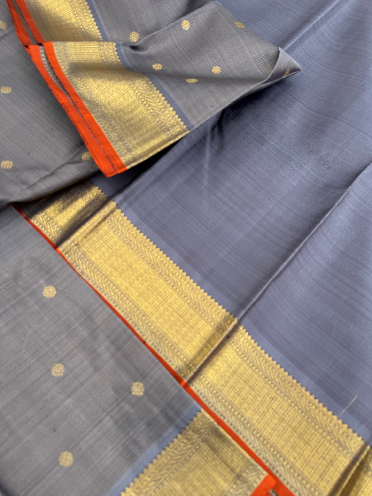 Molten Play on Kanchivaram - a stunning unusual molten Metallic grey vairaoosi the best part of the saree is the burnt orange sleeve edge