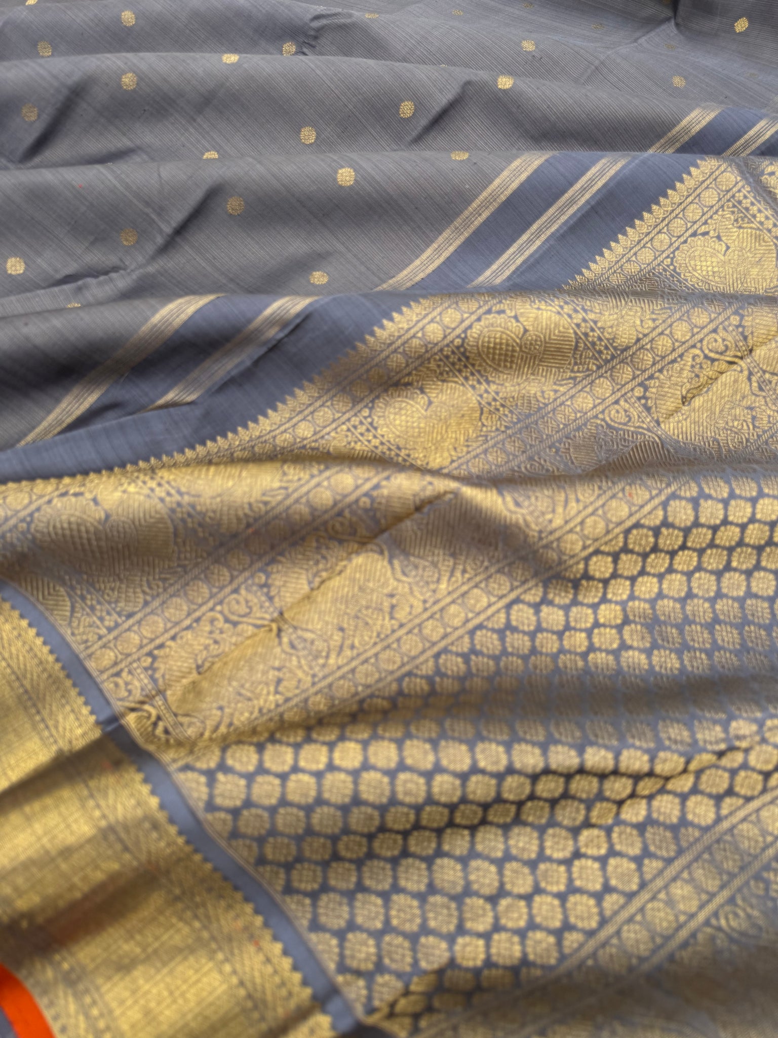 Molten Play on Kanchivaram - a stunning unusual molten Metallic grey vairaoosi the best part of the saree is the burnt orange sleeve edge