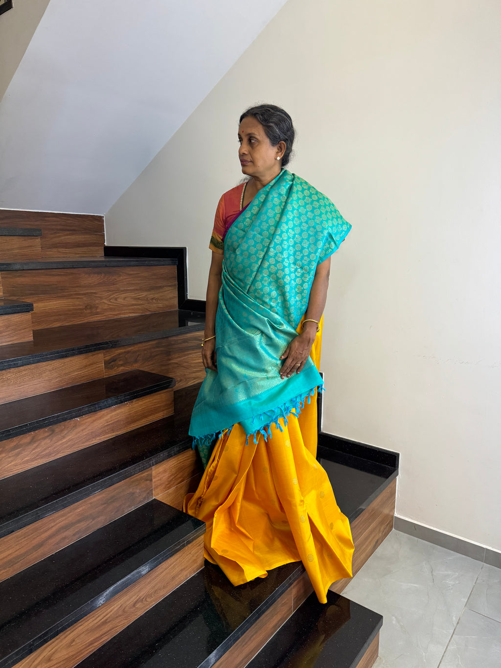 Kanchivaram Concepts - a stunning yellow and dual tone teal blue partly pallu kanchivaram with plain yellow pleats and full zari 1000 buttas woven front and pallu