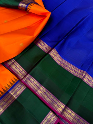 Tales of Korvais Kanchivaram - stunning carrot orange meenakshi green and intricate korvai woven borders