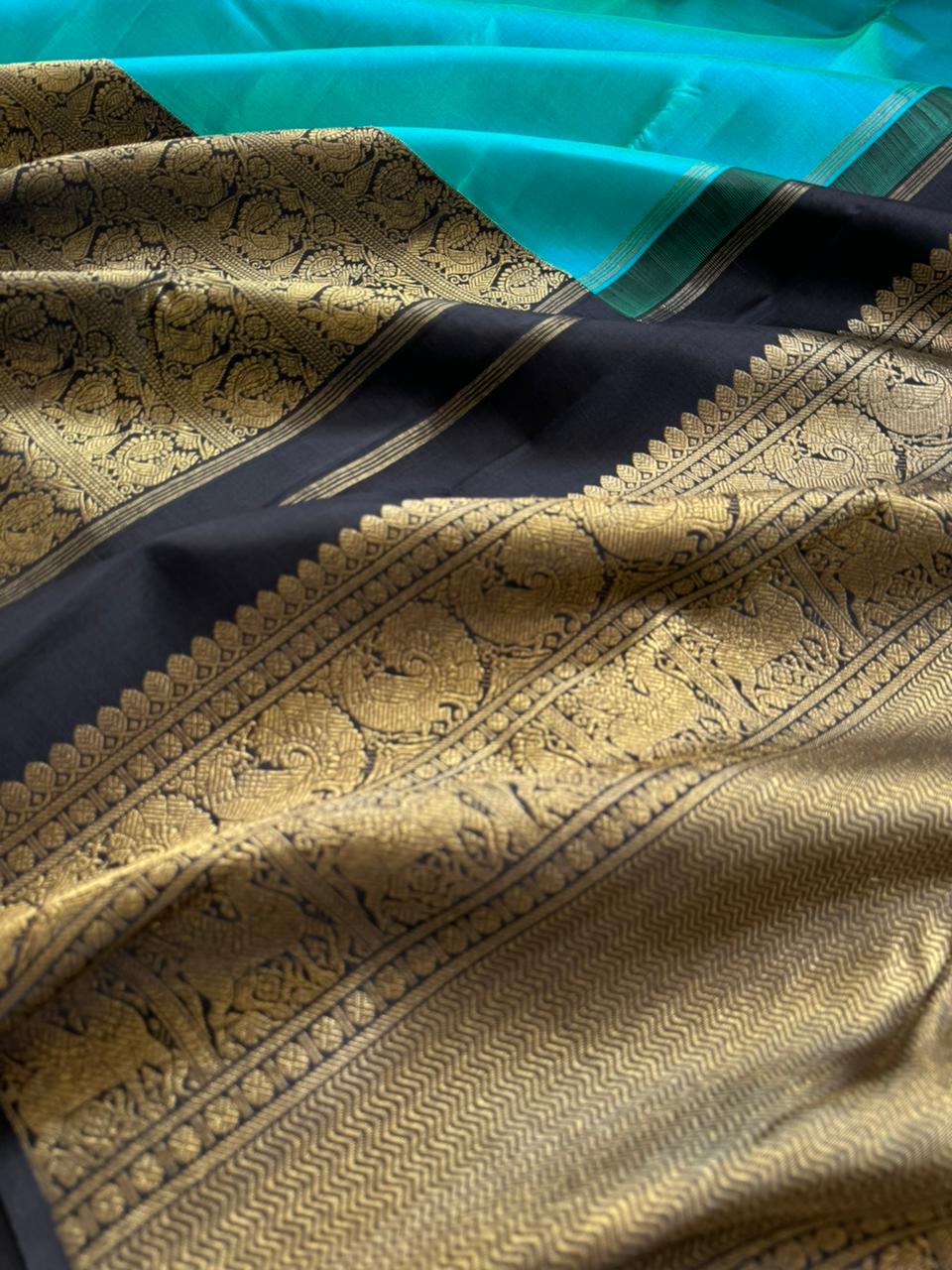 Tasteful Tall Border Kanchivarams - lovely dual tone blue and black with long zari woven one side korvai borders with grand pallu
