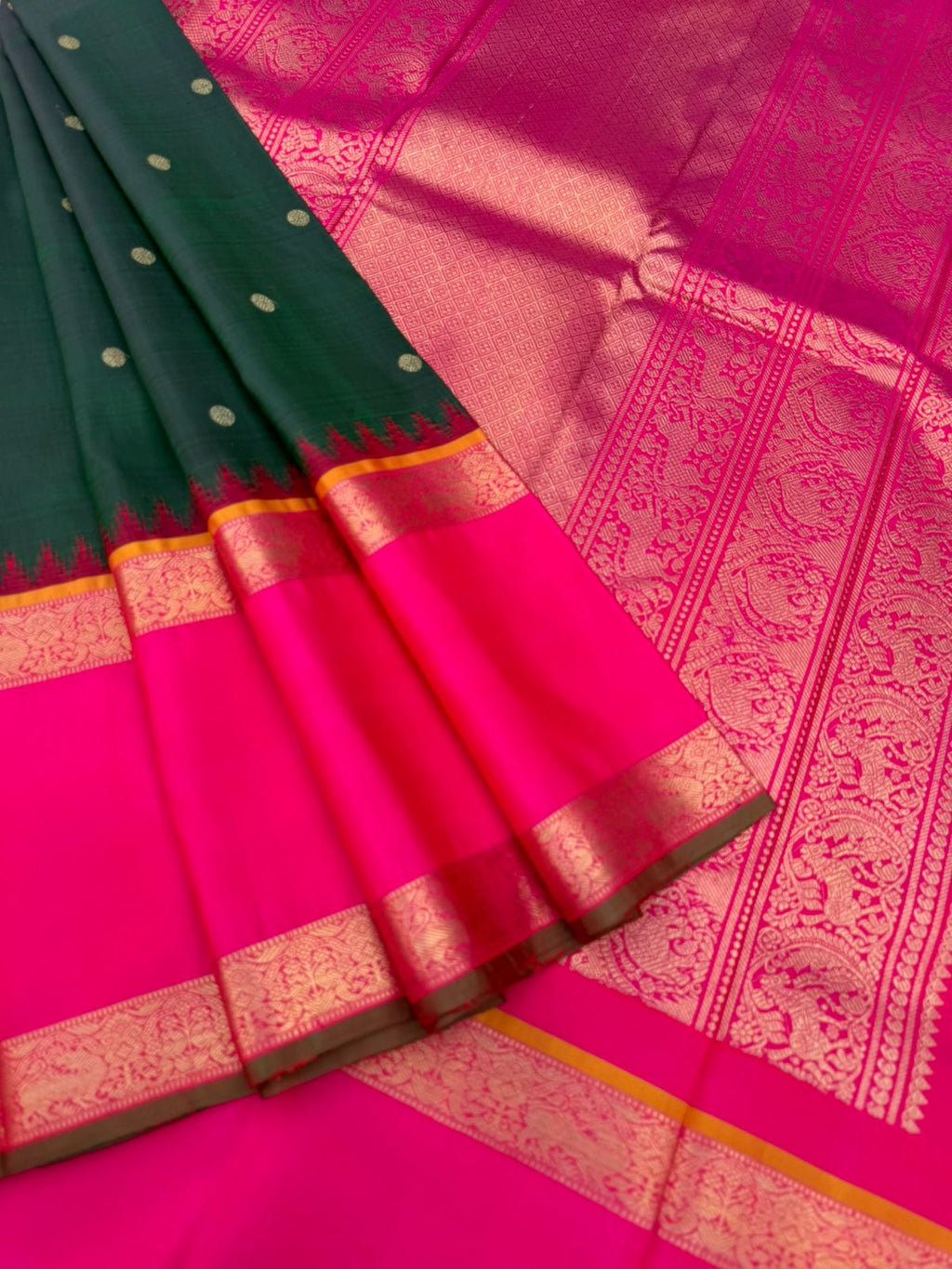 Colour Play on Kanchivaram - deep dark green and pink with broad korvai woven borders