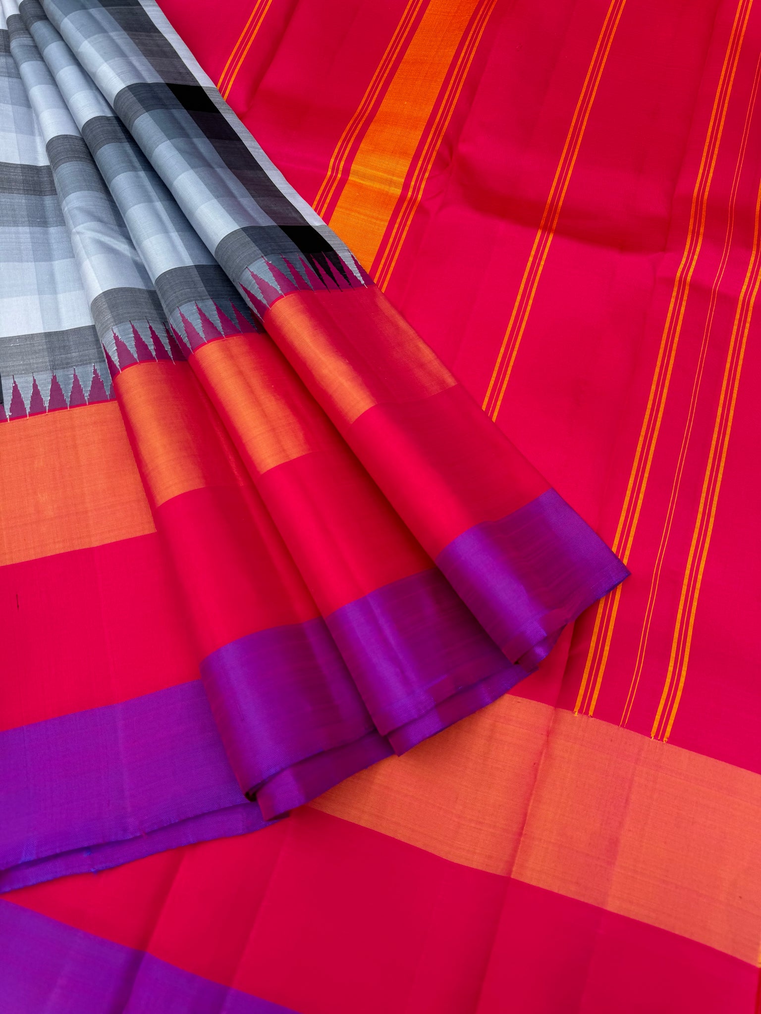 One of the most difficult Kanchivaram Silk - the weaver has to handle seven shuttles ( 5 for body and 2 for the borders ) digital grey black off white chex with three colour band woven borders