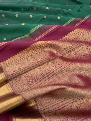 Colour Play on Kanchivaram - the beautiful deep dark meenakshi green with aaraku pallu and blouse with solid gold zari woven borders