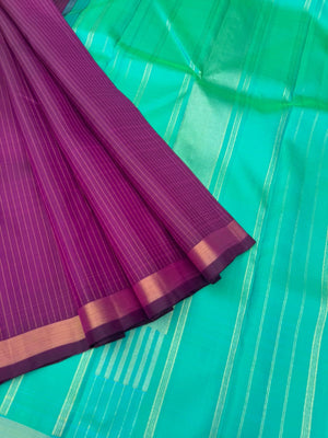 Shree - Simple and Elegant Kanchivarams - a stunning deep purple vertical muthu strips body with a dual tone turquoise blue pallu and blouse