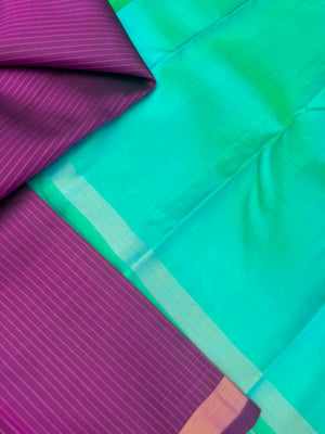 Shree - Simple and Elegant Kanchivarams - a stunning deep purple vertical muthu strips body with a dual tone turquoise blue pallu and blouse