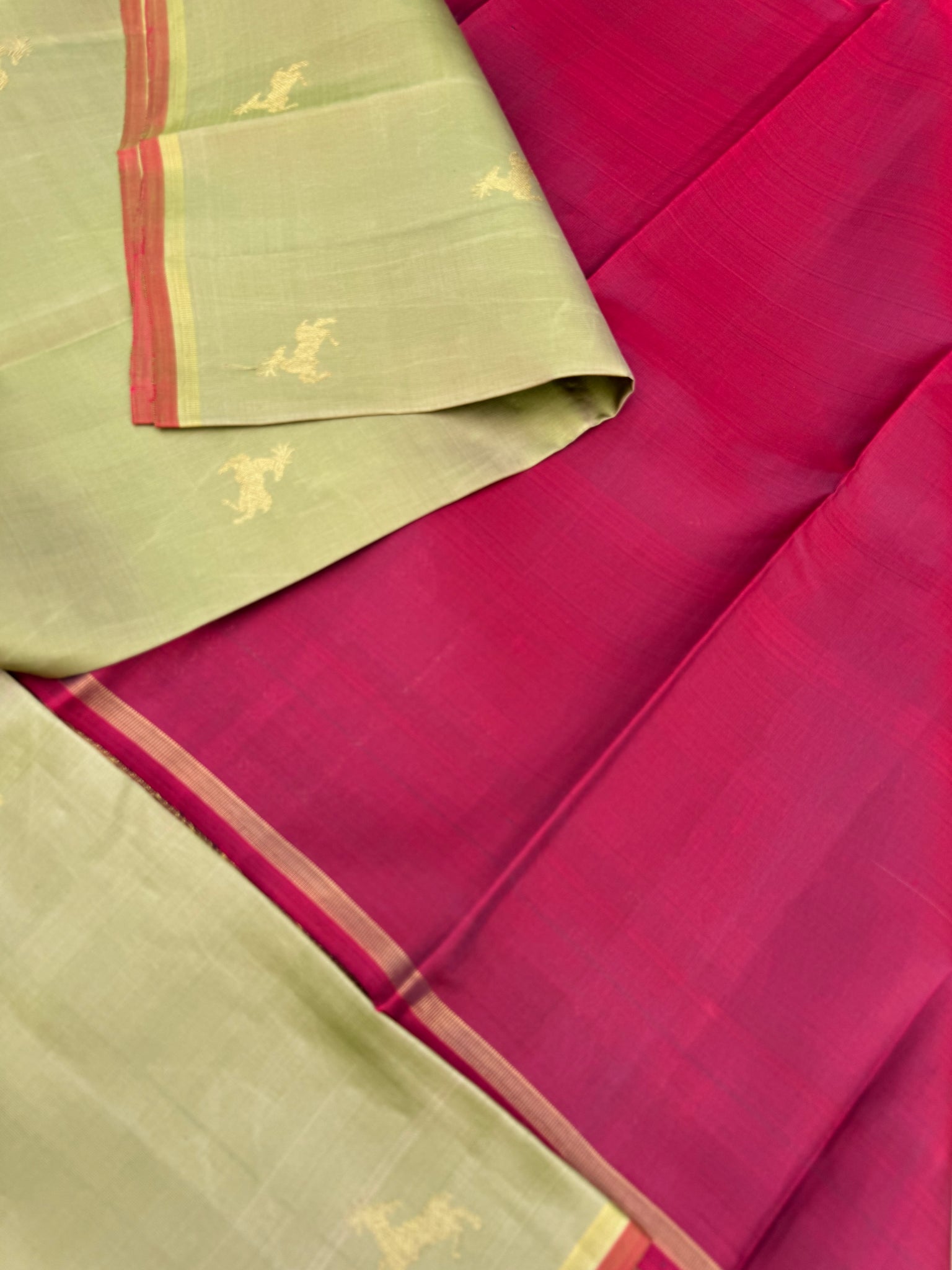 Corporate Kanchivarams - a pale elachi green and maroon borderless Kanchivaram with maan ( deer ) woven buttas