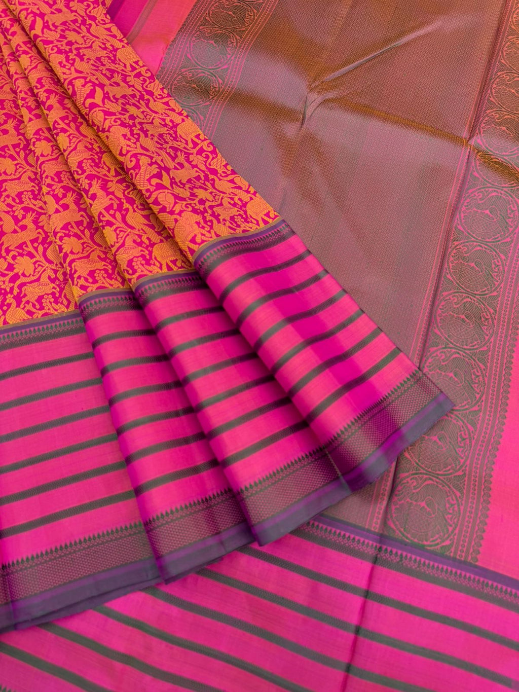 Vanasingaram on Kanchivaram - a pink base on motifs woven on mustard tone silk with varusai pett borders on no zari vanasingaram