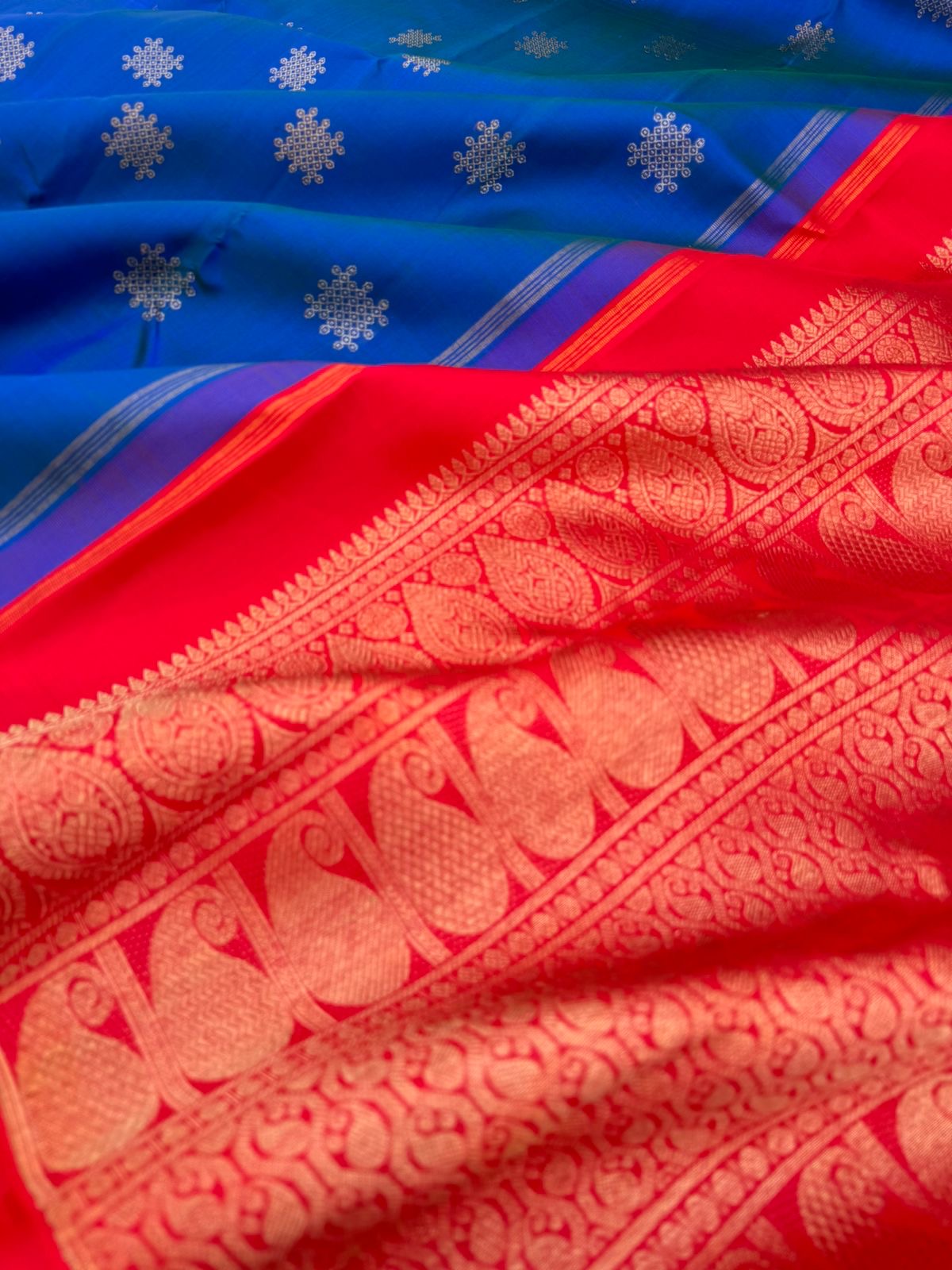 Colour Play on Kanchivaram - peacock blue green kolam buttas woven body with red tone woven pallu and blouse