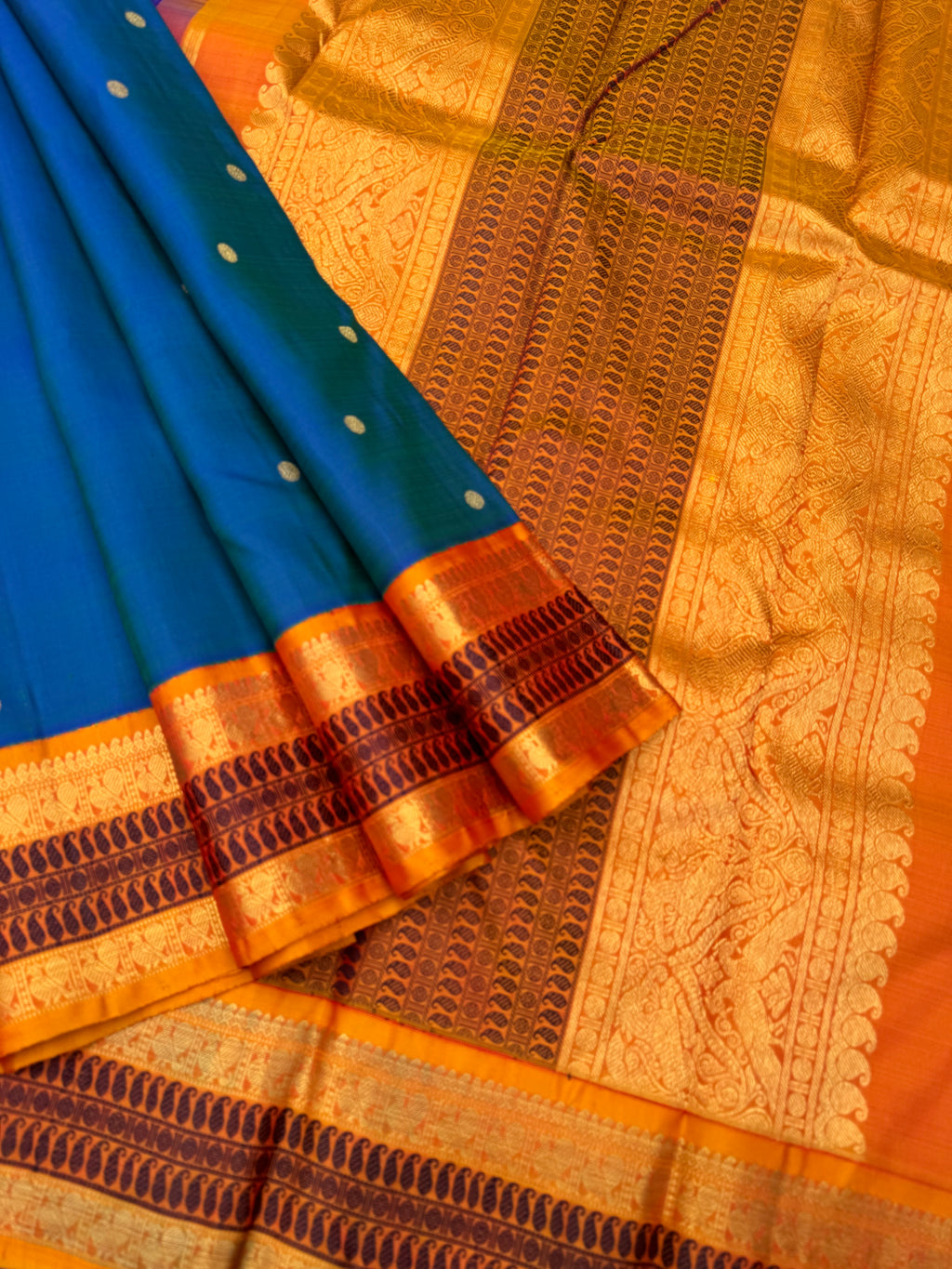 Aarambam - Where Tradition Begins - a classy peacock blue green body with vintage mustard zari and silk thread woven borders and pallu