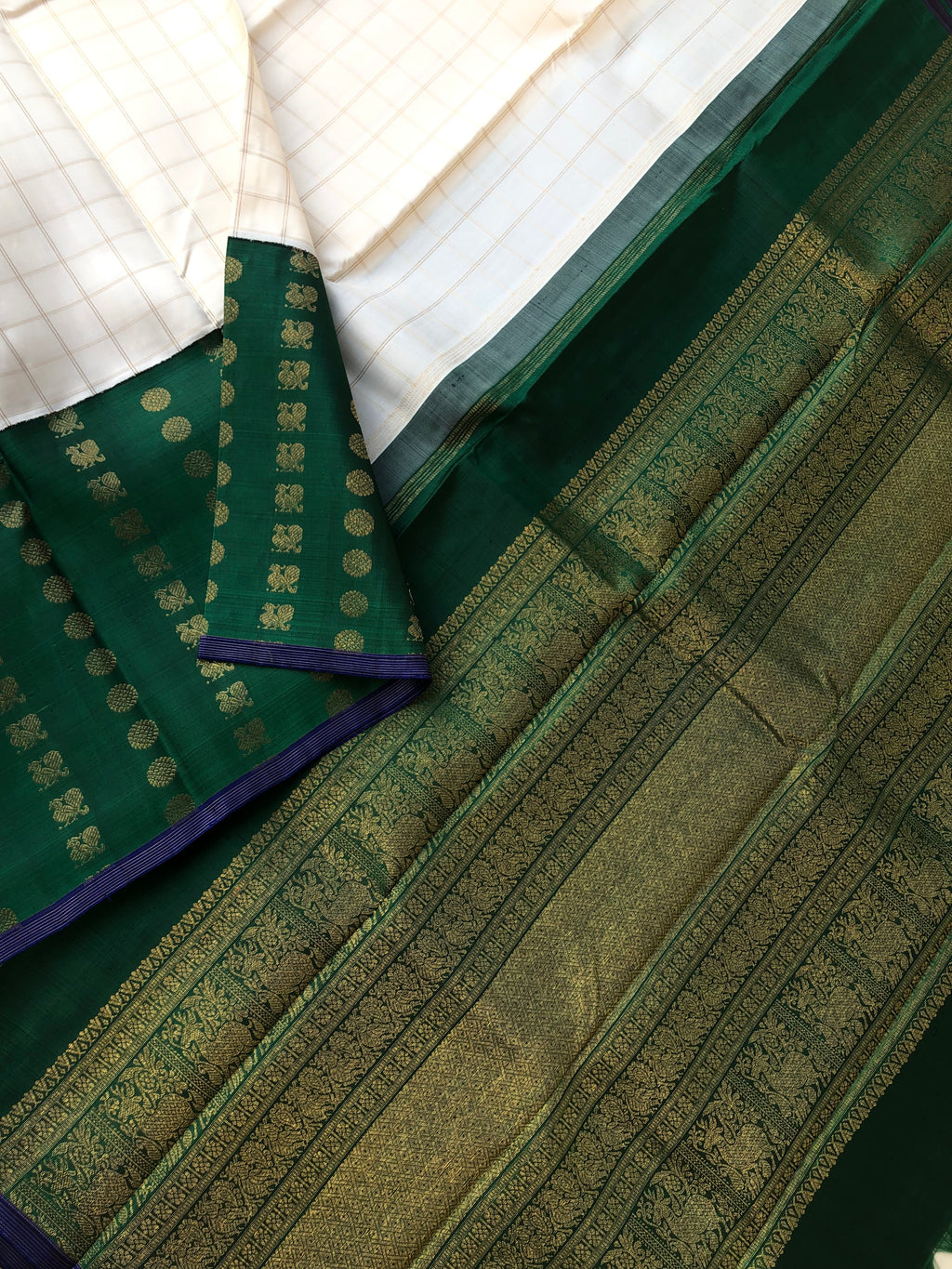 Kamakshi - One of  a Kind Kanchivaram - off white and Meenakshi green one side korvai woven skirt borders with 1000 buttas of mayil chackaram