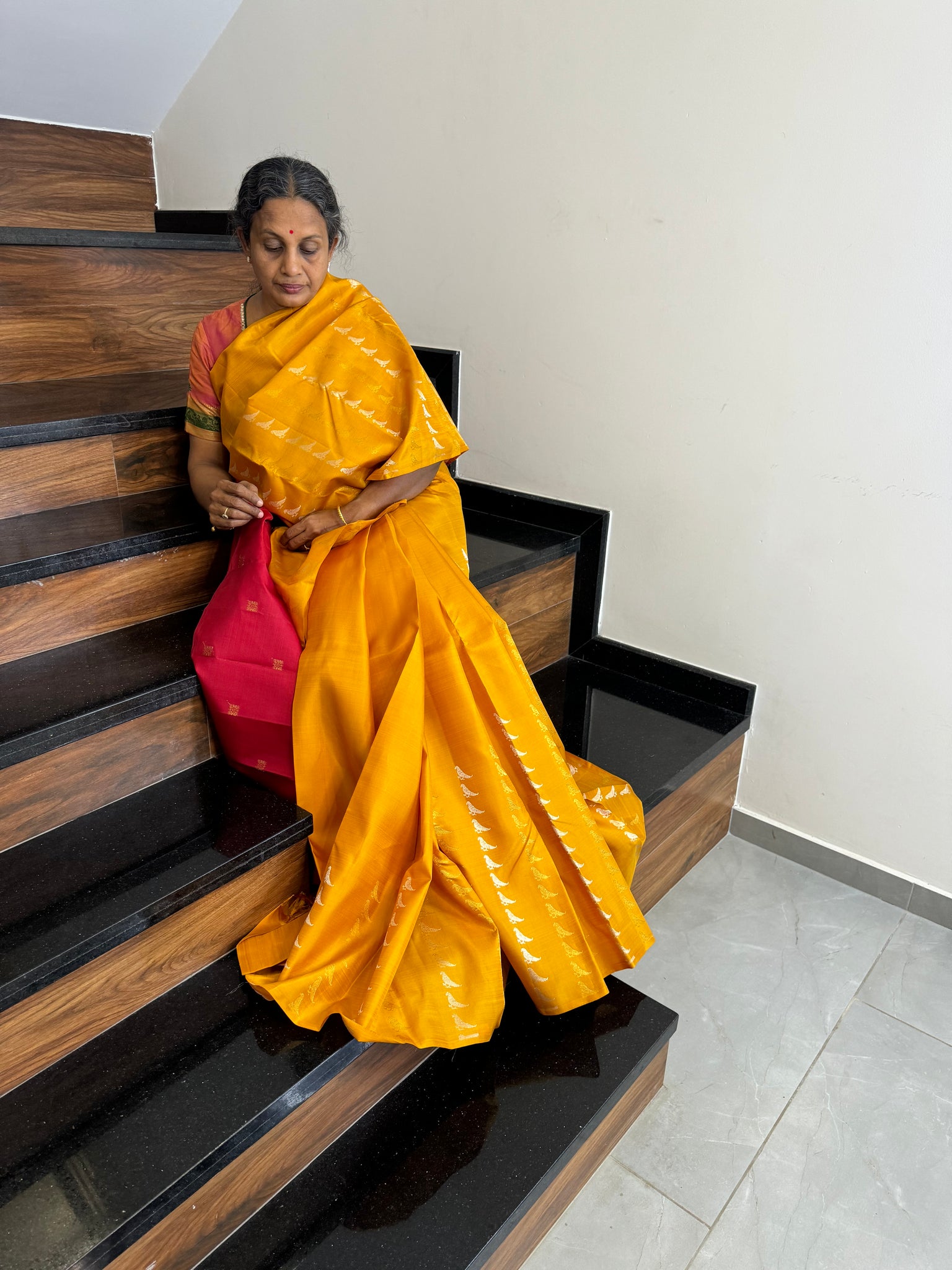 Kanchivaram Concepts - a amazing raising parrots of silver and gold zari woven buttas in a golden mustard body with red pallu and blouse